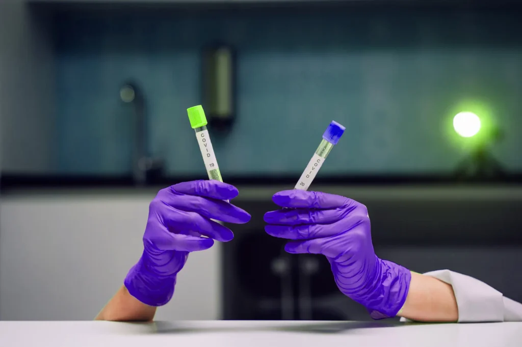 hands-rubber-gloves-holds-two-test-tube-with-coronavirus